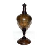 A lignum vitae and ebony plumb bob on stand, 29.5cm