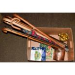 Antique brass pestle and mortar, a similar copper vessel, a quantity of walking sticks and