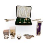 A collection of assorted silver, including four various napkin-rings, three modern decanter labels