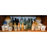 A quantity of glass and stoneware bottles including advertising examples, Ross & Co. Fleet, Giles