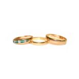 A 9 carat gold emerald and diamond seven stone ring, finger size J; a 9 carat gold band ring, finger