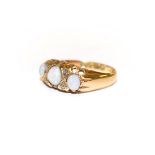 An 18 carat gold opal three stone ring with rose cut diamond accents, finger size M. Gross weight
