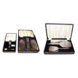 Two silver-mounted brush sets and a cased silver egg cup and spoon