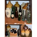 A quantity of antique glass and stoneware bottles with some advertising examples, including a