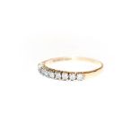 A 9 carat gold diamond half hoop ring, finger size P. Gross weight 1.4 grams.