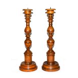 A pair of modern turned wooden pricket sticks, 43cm high