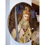 A large Continental pottery plaque decorated with a central portrait of a King, thought to
