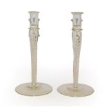 A pair of glass candlesticks, with plain nozzles and raised on airtwist stems, 25.5cm (2)