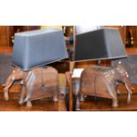 A large pair of carved oak novelty table lamps formed as stylised elephants with shades, base height