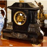 A large Victorian black slate striking mantel clock, dial centre with visible Brocot escapement,