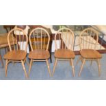 A set of four light elm hoop back dining chairs