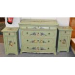 A three piece green painted pine bedroom suite decorated with fruit, comprising a four height