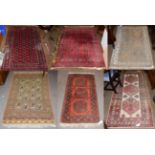 An Afghan rug, the crimson field with three rows of guls enclosed by octagon motif borders, 178cm by