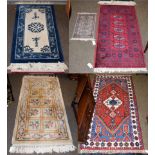 A machine made ''Afghan'' rug, the crimson field with five guls, 137cm by 69cm, together with four