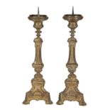 ^ A Pair of Gilt Metal Altar Candlesticks, late 19th/early 20th century, each with shaped baluster