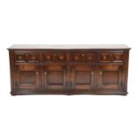 David Semple: A Reproduction Oak Sideboard, in 17th century style, the moulded top above four two-