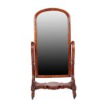 A Victorian Mahogany Cheval Mirror, circa 1870, the original mirror plate within an arched frame