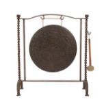 ~ An Early 20th Century Cast Iron Dinner Gong, with spiral turned supports suspending a brass