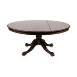 ~ A Late 19th Century Carved Mahogany Circular Dining Table, the fliptop with carved and gadrooned