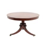 {} A Regency Mahogany and Rosewood Circular Dining Table, early 19th century, the fliptop above a