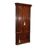 An 18th Century Style Oak Free-Standing Corner Cupboard, the breakfront moulded cornice above two