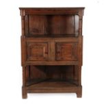 A Joined Oak Standing Livery Cupboard, early 18th century, the moulded top above chamfered and punch