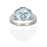 A 9 Carat White Gold Blue Topaz and Diamond Ring, the fancy cut blue topaz with an eight-cut diamond
