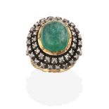 An Indian Emerald and Diamond Cluster Ring, the oval cabochon emerald in a yellow collet setting,