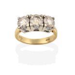 An 18 Carat Gold Diamond Three Stone Ring, the round brilliant cut diamonds in white four claw
