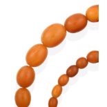 An Amber Bead Necklace, formed of twenty-nine graduated amber beads, length 44.5cm see