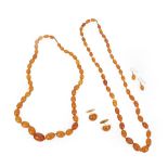 Two Amber Bead Necklaces, formed of forty-one and forty-four graduated amber beads, lengths 63cm and