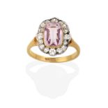 A Pink Tourmaline and Diamond Cluster Ring, the cushion cut pink tourmaline in a yellow rubbed