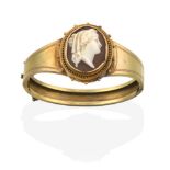 A Victorian Cameo Bangle, the oval cameo depicting a lady in profile, within a yellow ropetwist