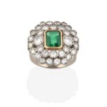 An Emerald and Diamond Ring, the emerald-cut emerald in a yellow rubbed over setting, within a