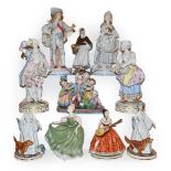 Two trays of porcelain figures including a German coloured bisque group 'blind mans bluff', two