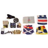 A merchant naval cap and gilt brass plaque, various signalling flags, rigging block, a 19th