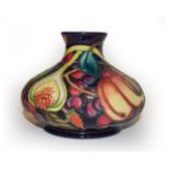 A modern Moorcroft vase with fruit pattern impressed factory marks