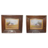 A pair of 20th century Crown Devon fielding porcelain plaque painted with scenes of gun dogs in