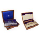 An Edwardian oak cased set of silver and mother of pearl dessert knives and forks by Goldsmiths &