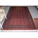 A Lahora 'Bukhara' rug , the claret field with rows of guls enclosed by multiple borders, 280cm by