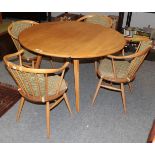 A light elm Ercol drop leaf table 123cm by 114cm by 72cm together with four matching horseshoe