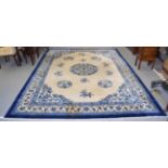 Chinese carpet the cream field with roundel medallion framed by borders of angular floral vines,