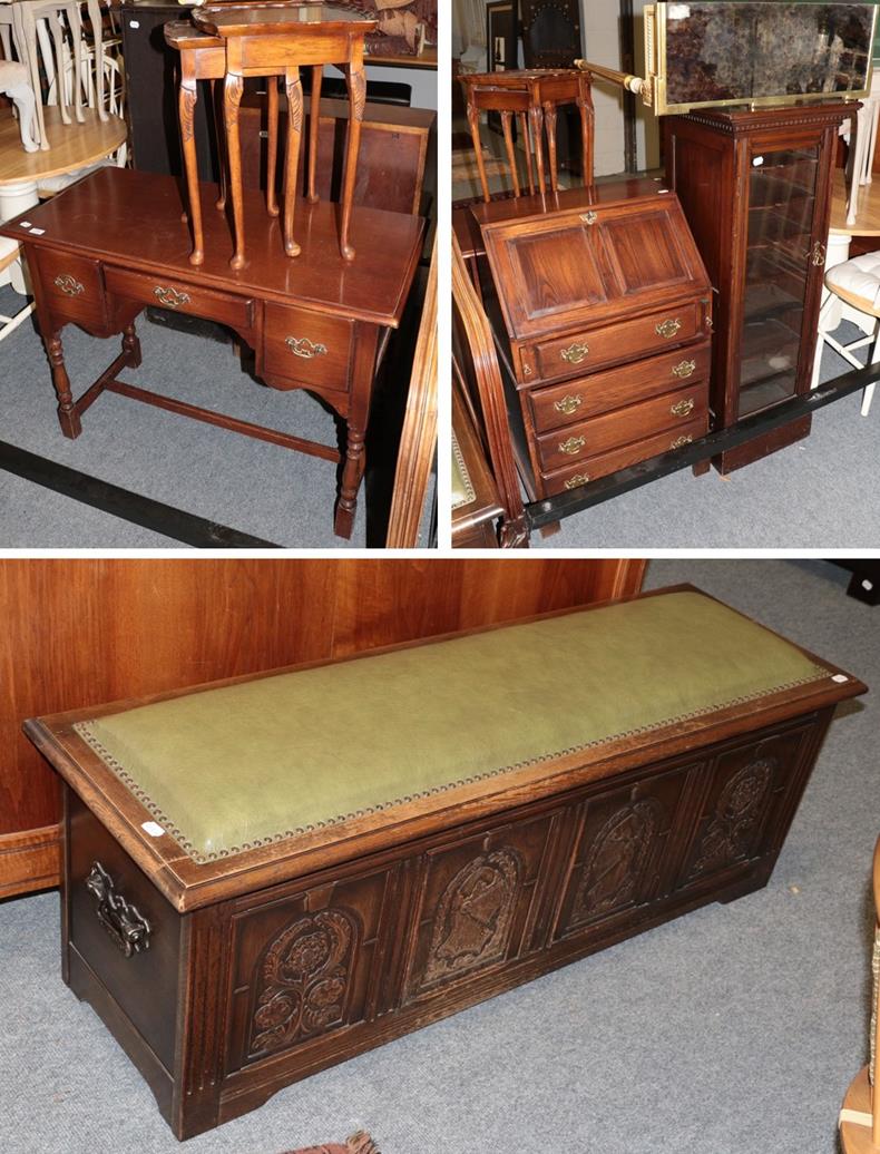 A modern carved oak four panel blanket chest, the panels carved with knights and flowers, the hinged