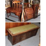 A modern carved oak four panel blanket chest, the panels carved with knights and flowers, the hinged