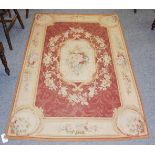 A Chinese 'Aubusson' rug, the brick red field of acanthus leaves centred by a floral panel