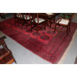 An Afghan Turkmen carpet, the crimson field with four rows of elephant foot guls enclosed by