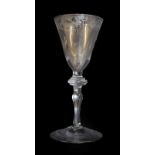 A Light Baluster Wine Glass, circa 1740, the rounded funnel bowl engraved with a border of birds,