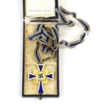 A German Third Reich Mother's Cross in Gold, in blue leather cloth case, the interior marked