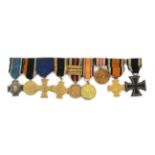 A First World War Iron Cross, second class, magnetic, the suspender ring maker marked 100; a Group