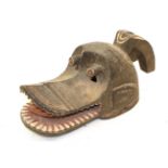 A 20th Century Mambila Dog Head Mask, Cameroon, carved in wood covered in brown, cream and red